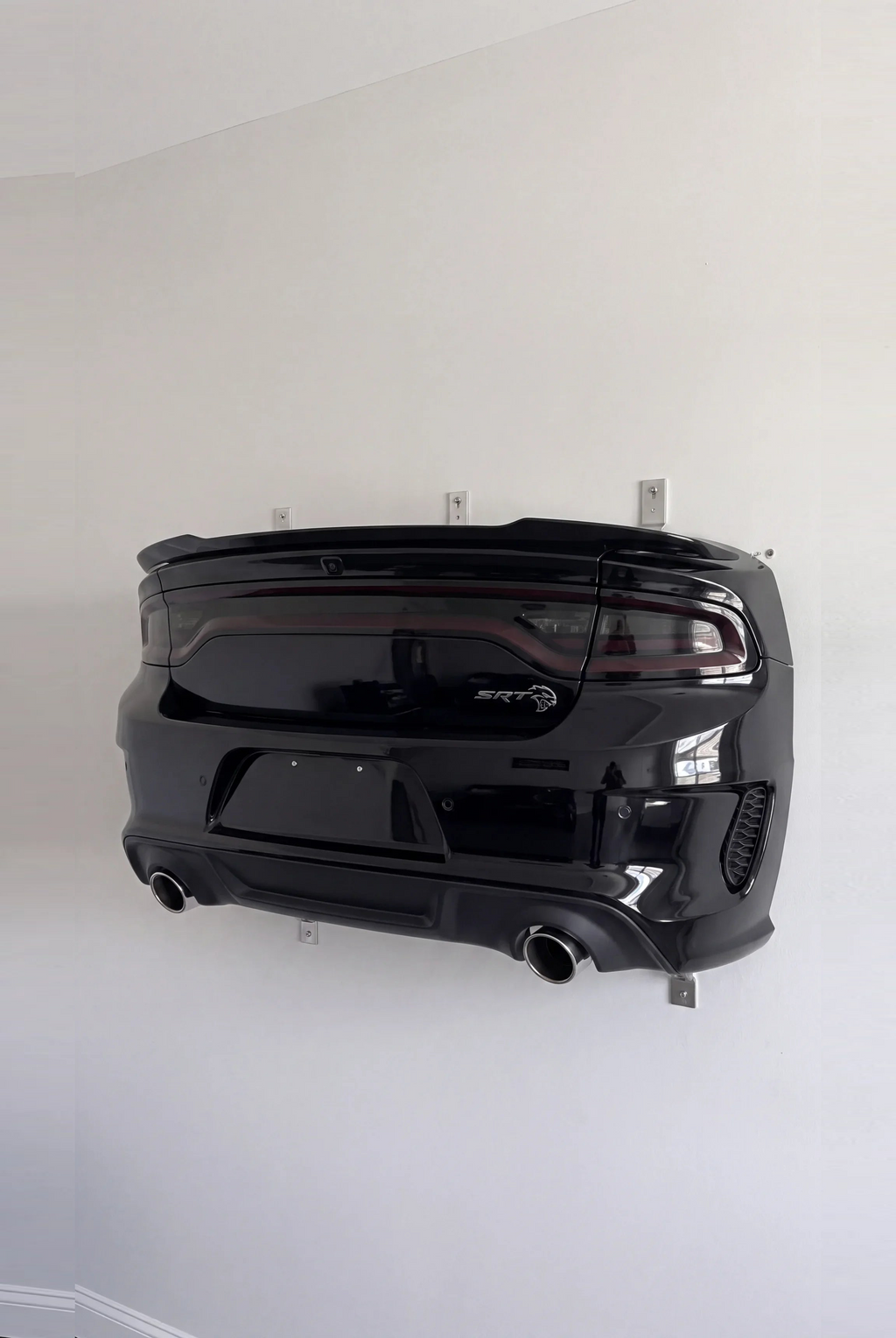 Dodge Charger style WingMount car shelf in gloss black on a living room wall