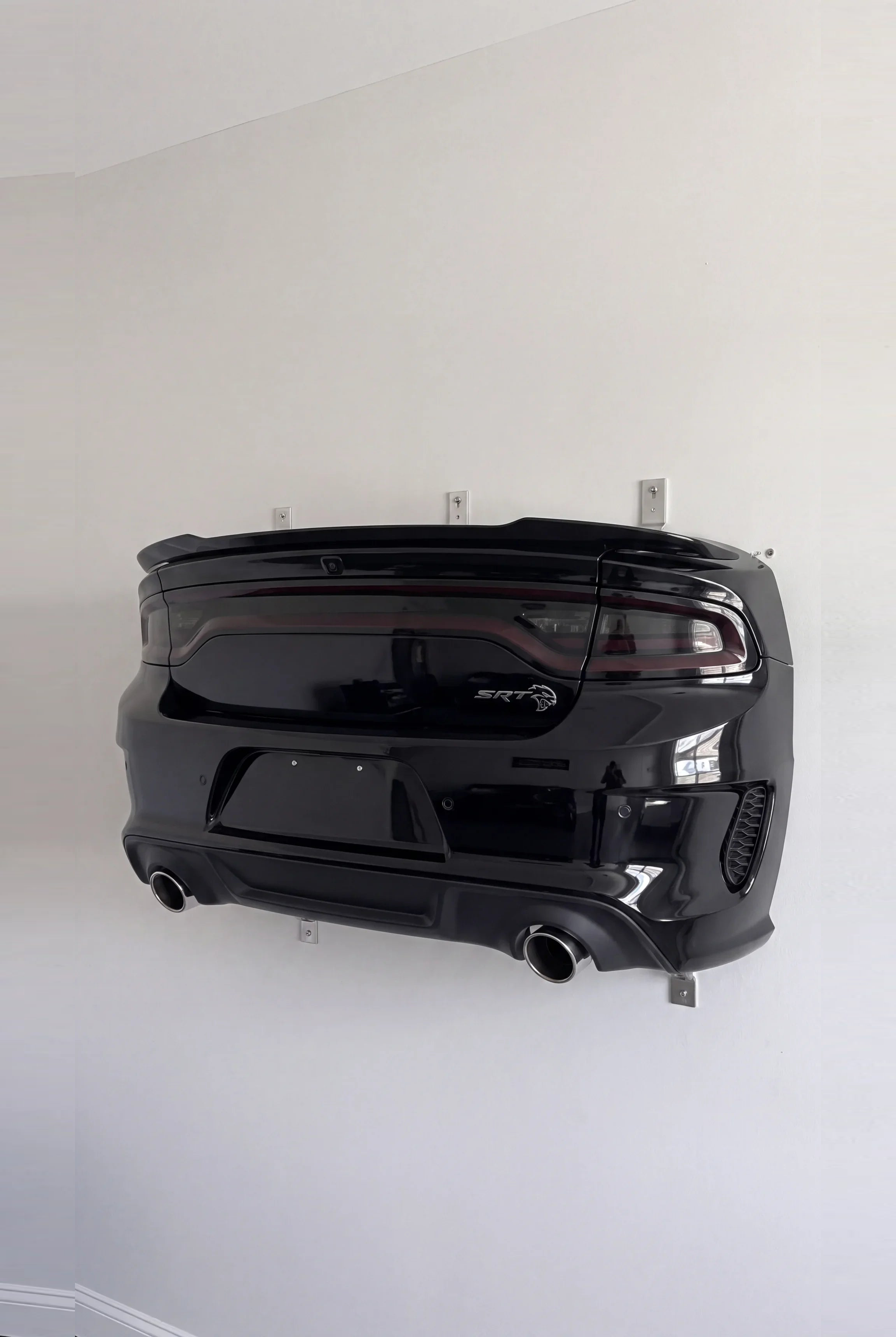 Dodge Charger style WingMount car shelf in gloss black on a living room wall
