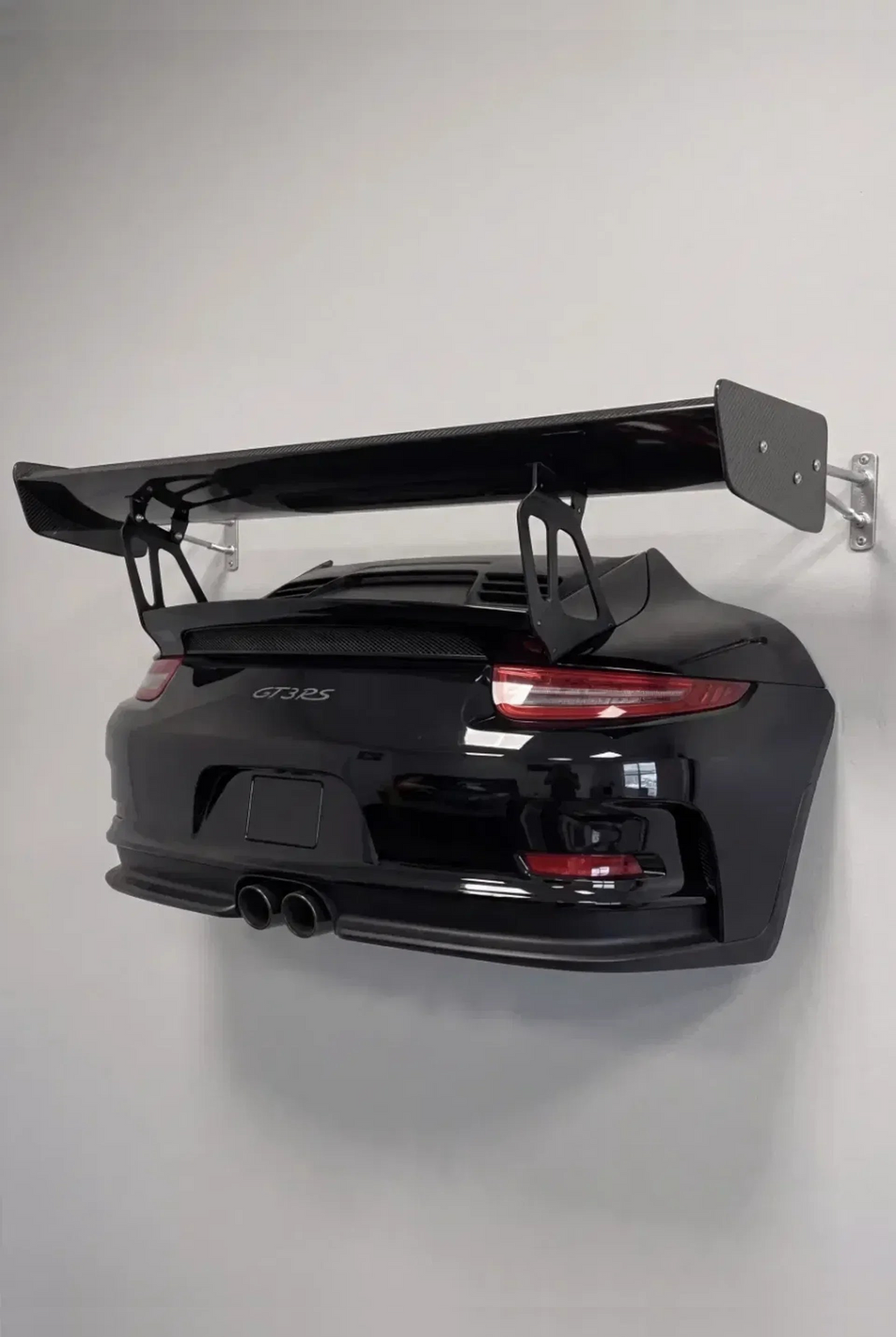 WingMount wall mounted car shelf in matte black, mounted above a gaming desk
